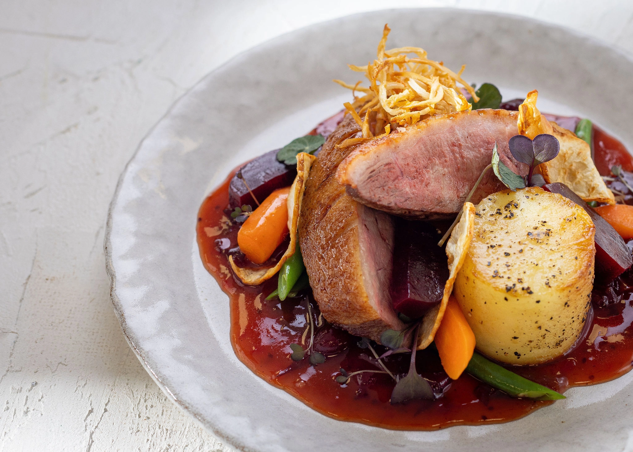 Duck Breast with Fondant Potato, Baby Veg and Cranberry Sauce